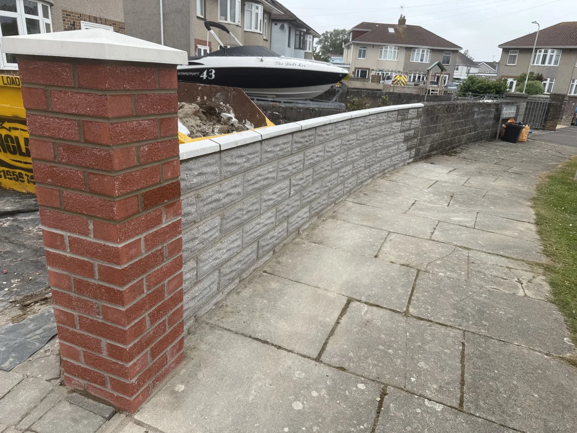 Brick boundary wall with pier and coping stones in Cardiff