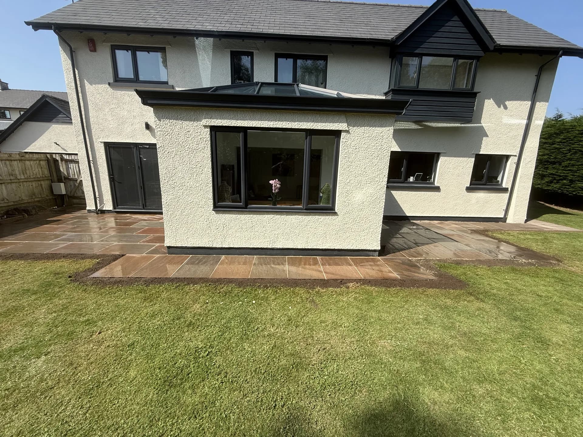 House extension with skylight and patio in Bridgend